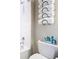 White tiled bathroom with bathtub and towel rack at 16300 County Road 455 # 610, Montverde, FL 34756
