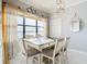 Bright dining area with lake view and charming table at 16300 County Road 455 # 610, Montverde, FL 34756