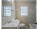 Clean bathroom with white vanity, bathtub, and marble-tiled shower at 1639 Hialeah St, Orlando, FL 32808
