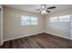 Spacious bedroom with dark hardwood floors and ceiling fan at 1639 Hialeah St, Orlando, FL 32808