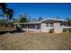 Side view of a renovated single story home with a spacious yard at 1639 Hialeah St, Orlando, FL 32808
