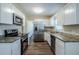 Updated kitchen with stainless steel appliances and granite countertops at 1639 Hialeah St, Orlando, FL 32808