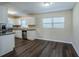 Modern kitchen with white shaker cabinets, granite counters, and stainless steel appliances at 1639 Hialeah St, Orlando, FL 32808