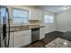 Renovated kitchen featuring white cabinets, granite countertops, and stainless steel appliances at 1639 Hialeah St, Orlando, FL 32808