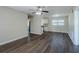 Spacious living room with dark laminate wood flooring and ceiling fan at 1639 Hialeah St, Orlando, FL 32808