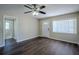 Bright living room featuring dark laminate flooring and view into bathroom at 1639 Hialeah St, Orlando, FL 32808