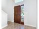 Entryway has tiled floors and a wooden door with stained glass at 21343 Reindeer Rd, Christmas, FL 32709