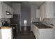 Modern kitchen with white cabinets, butcher block countertops and hexagon backsplash at 2406 S Lake Avenue Ave, Sanford, FL 32771