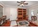 Home office with built-in shelving and hardwood floors at 3032 Harbour Landing Way, Casselberry, FL 32707