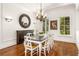 Formal dining room with wood table, white chairs, and hardwood floors at 4424 New Broad St, Orlando, FL 32814