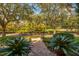 Landscaped front yard with mature trees and brick walkway at 4424 New Broad St, Orlando, FL 32814