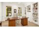Bright home office featuring built-in shelves and a large desk at 4424 New Broad St, Orlando, FL 32814