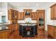 Gourmet kitchen with wood cabinets, granite island, and stainless steel appliances at 4424 New Broad St, Orlando, FL 32814