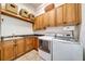 Laundry room with washer, dryer, cabinets, and sink at 4424 New Broad St, Orlando, FL 32814