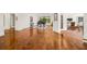 Spacious living area with hardwood floors, grand piano, and access to other rooms at 4424 New Broad St, Orlando, FL 32814