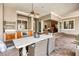 Covered patio with outdoor kitchen, dining area, and fireplace at 4424 New Broad St, Orlando, FL 32814