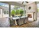 Covered patio with fireplace and dining area, adjacent to pool at 4424 New Broad St, Orlando, FL 32814
