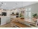 Kitchen dining area with farmhouse table, bench seating, and access to the backyard at 663 Caterpillar Run, Winter Garden, FL 34787