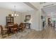 Bright dining area with a wooden table and view into the living room at 663 Caterpillar Run, Winter Garden, FL 34787