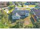 Aerial view of the home showing the roof, backyard, screened in lanai and surrounding greenery at 1161 Roxboro Rd, Longwood, FL 32750