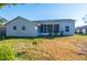 Exterior view of home featuring a screened in lanai and spacious backyard at 1161 Roxboro Rd, Longwood, FL 32750