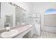 Bright bathroom featuring double sinks, a glass shower, and a clean, modern design at 1161 Roxboro Rd, Longwood, FL 32750