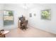 Bright bedroom featuring large windows, neutral carpet, and a dedicated workspace with desk at 1161 Roxboro Rd, Longwood, FL 32750