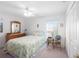 Cozy bedroom with a ceiling fan, wooden dresser, and soft, floral-patterned bedding at 1161 Roxboro Rd, Longwood, FL 32750