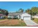 Charming single-story home featuring a well-manicured lawn and an attached two-car garage at 1161 Roxboro Rd, Longwood, FL 32750