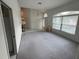 Bright living room with large windows, neutral carpet, and high ceilings, creating a welcoming atmosphere at 1161 Roxboro Rd, Longwood, FL 32750