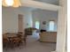 Open concept living room with dining area, neutral tones, and large windows for natural light at 1161 Roxboro Rd, Longwood, FL 32750