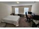 Bright bedroom with a bed, desk, and window coverings at 11743 Stein St, Orlando, FL 32832