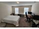 Bright bedroom with a bed, desk, and window coverings at 11743 Stein St, Orlando, FL 32832