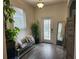 Bright and airy entryway with tile flooring, bench, and large mirror at 11743 Stein St, Orlando, FL 32832
