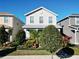 Two-story house with light beige siding, landscaping, and a front porch at 11743 Stein St, Orlando, FL 32832