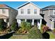 Two-story house with light beige siding, landscaping, and a front porch at 11743 Stein St, Orlando, FL 32832