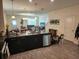Modern kitchen featuring dark cabinetry, stainless steel appliances, and an island at 11743 Stein St, Orlando, FL 32832