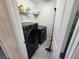 Bright laundry room with washer, dryer, and shelving at 11743 Stein St, Orlando, FL 32832