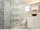 Updated bathroom features a walk-in shower, modern vanity, and marble tile at 1310 Ridge Rd, Longwood, FL 32750