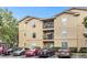 Tan three-story building with parking lot and several cars at 1341 Arbor Vista Loop # 113, Lake Mary, FL 32746