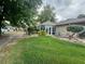 Backyard view showcasing a sunroom and lush landscaping at 1641 Lake Marion Dr, Apopka, FL 32712