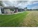 Backyard view with screened patio and AC unit at 1641 Lake Marion Dr, Apopka, FL 32712