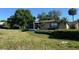Tan house exterior with screened porch, landscaping and statue at 1641 Lake Marion Dr, Apopka, FL 32712