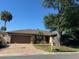 Single-story home with a paved driveway and landscaping at 1641 Lake Marion Dr, Apopka, FL 32712