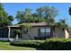 House exterior with brown roof, screened patio, and landscaping at 1641 Lake Marion Dr, Apopka, FL 32712