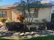 Tan house exterior with landscaping and stone accents at 1641 Lake Marion Dr, Apopka, FL 32712