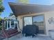 Covered patio with a grill and seating area at 1641 Lake Marion Dr, Apopka, FL 32712