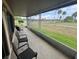 Screened porch with wicker chairs overlooking a grassy area at 1641 Lake Marion Dr, Apopka, FL 32712