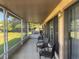 Relaxing screened porch with wicker chairs and backyard view at 1641 Lake Marion Dr, Apopka, FL 32712