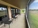 Relaxing screened porch with wicker chairs and view at 1641 Lake Marion Dr, Apopka, FL 32712
